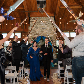 Wedding couple under sword arch at Gold Mountain Golf Club