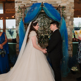 Bride and groom holding hands at a Gold Mountain Golf Club wedding