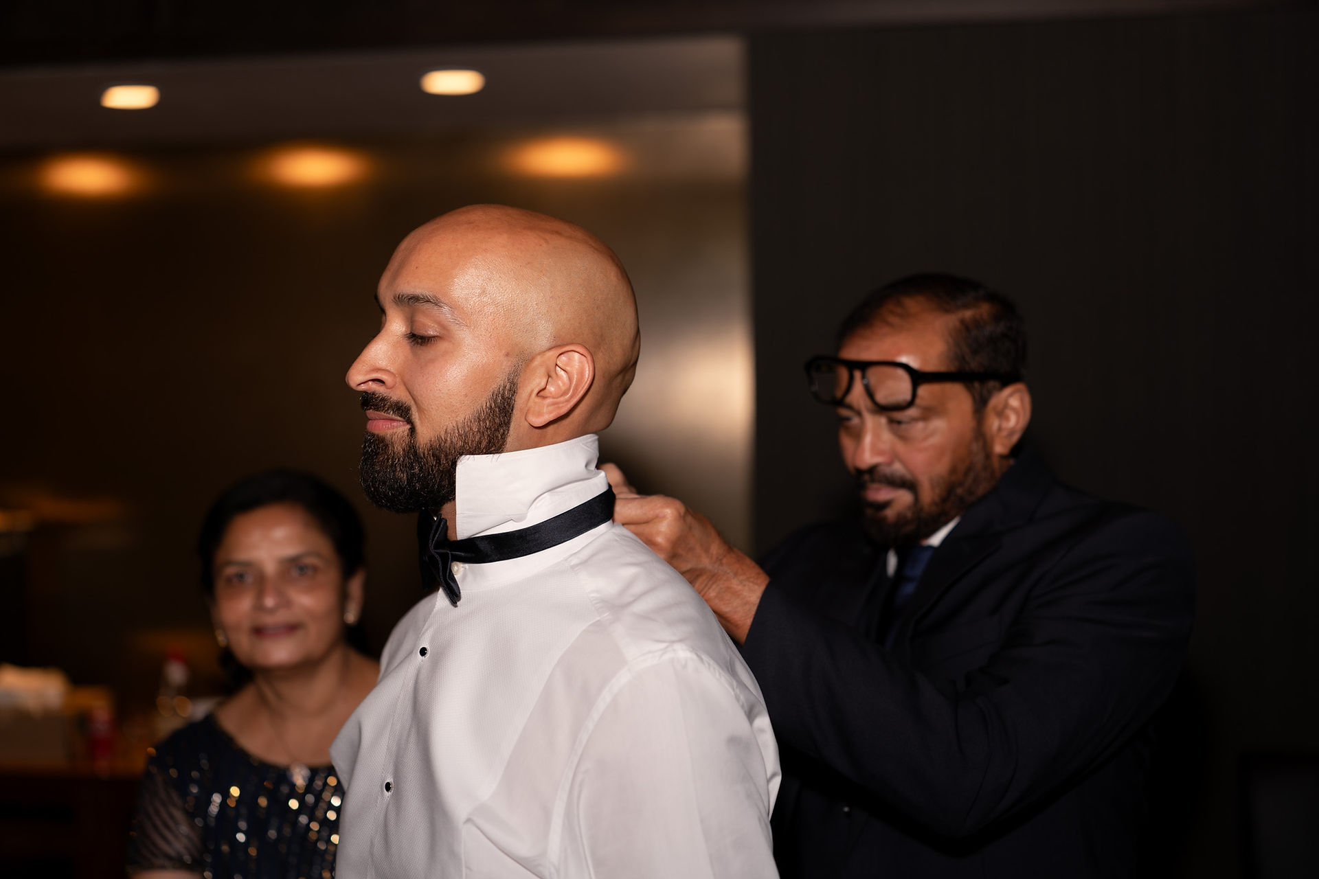 Father helping groom with bow tie by WA Wedding Photographer