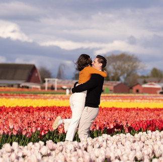 Couple embracing in a colorful tulip field at Skagit Tulip Festival