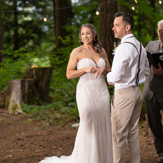 Bride and groom exchange rings at Forest Creek Darrington WA.