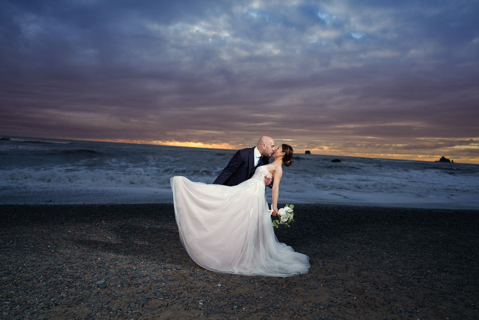 Couple kissing on a beach at sunset during their Olympic National Park elopement.