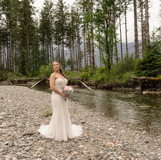 Bride posing by the river at Forest Creek Darrington WA.