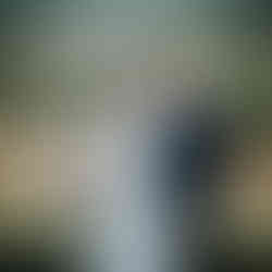 Happy bride and groom holding hands, celebrating their countryside wedding.