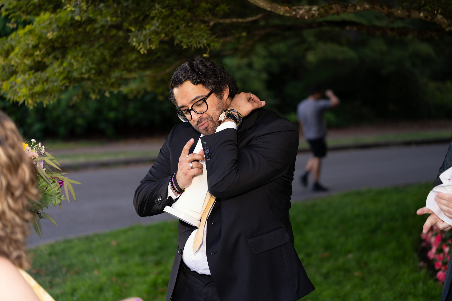 Groom adjusting tie at Volunteer Park Conservatory in Seattle