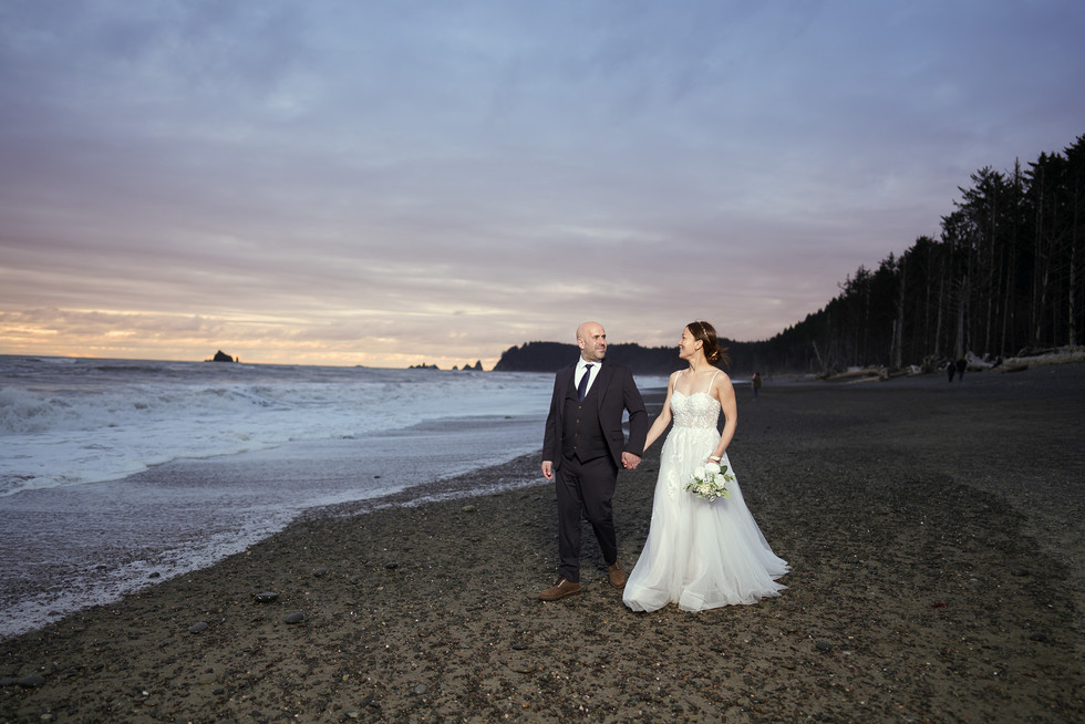 Elopement couple walking on Ruby Beach, Olympic National Park.