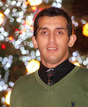 Man in green sweater with Christmas lights background PhotoYari wedding photographers near me