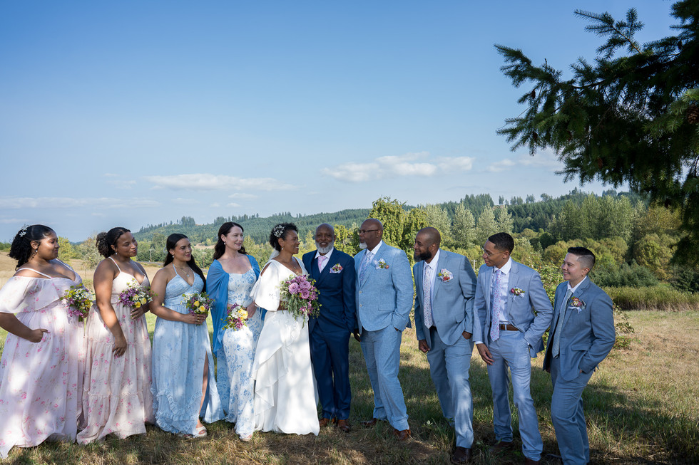 Wedding party smiling outdoors at an intimate farm wedding.