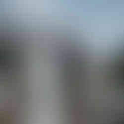Bride and man walk towards decorated wedding arch at intimate farm wedding.