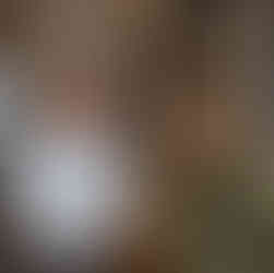 Man and woman conversing near framed art