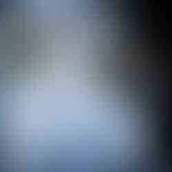 White dresser displaying a wedding cake, cupcakes, and vibrant floral arrangements.