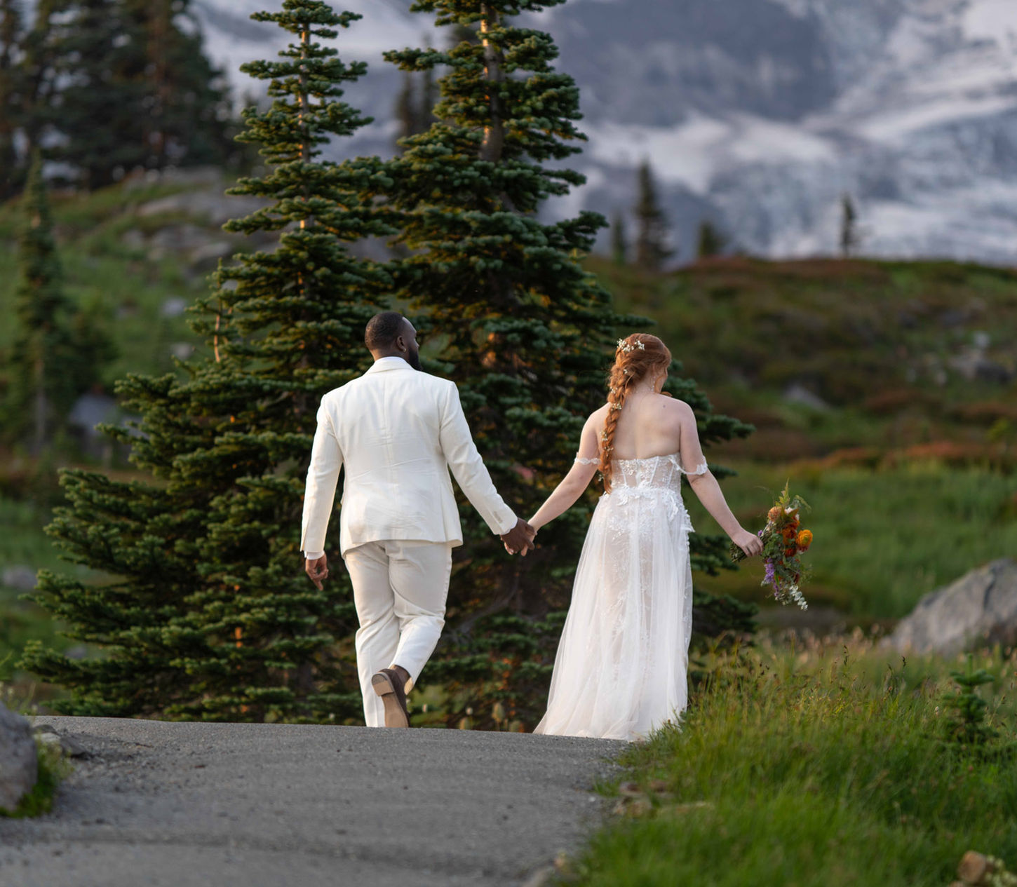 Couple walking hand-in-hand, mountain landscape backdrop, Elopement, PNW setting.