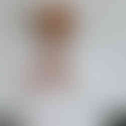 Bearded man in glasses adjusting pink patterned tie for event.