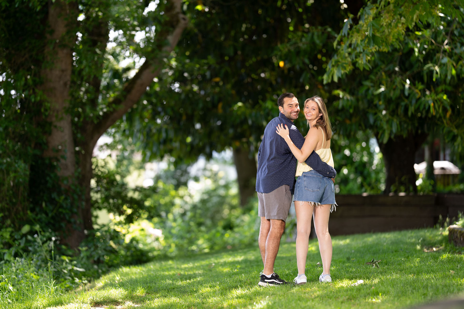 Happy couple embracing, Green Lake proposal