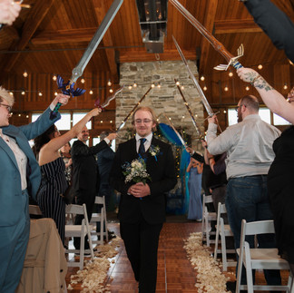 Groom walks under swords at Gold Mountain Golf Club wedding