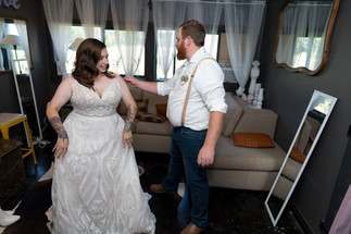 Smiling bride and groom share tender moment on their wedding day.