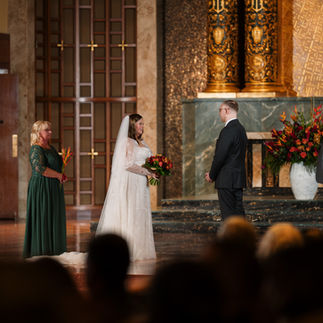 Bride and groom exchanging vows at a beautiful chapel wedding ceremony.