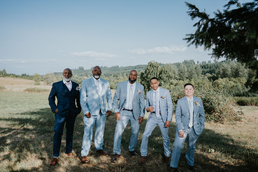 Groomsmen in blue suits pose outdoors for Intimate Farm Wedding.
