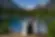 Couple exchanging vows by mountain lake