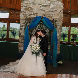 Bride and groom kissing at Gold Mountain Golf Club wedding