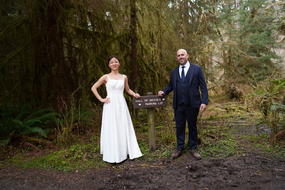 Couple at Hall of Mosses Trail Entrance sign, Olympic National Park elopement