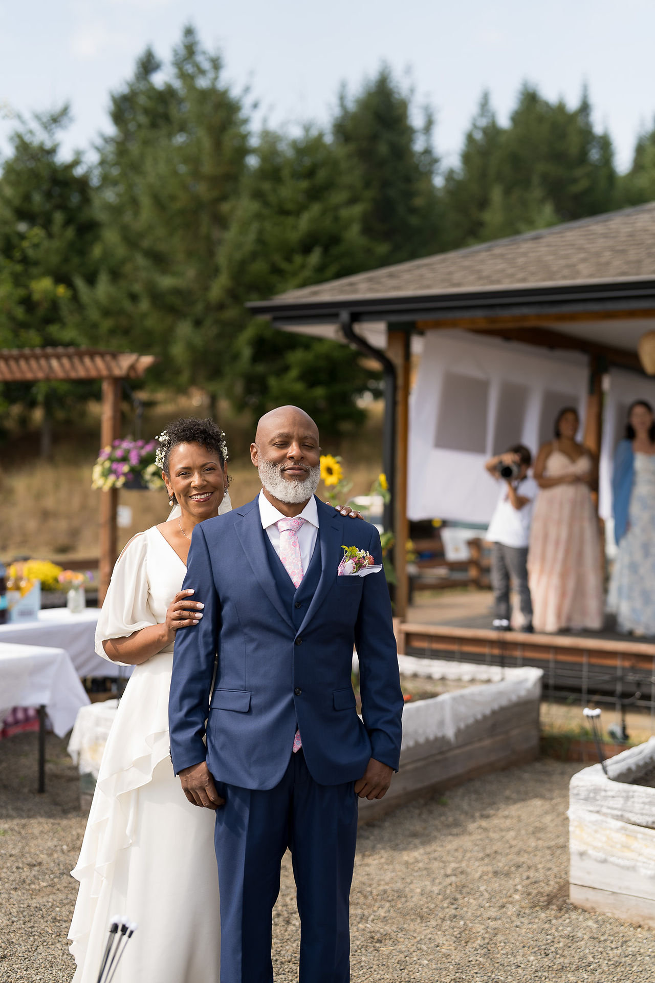 Newlywed couple smiling at their intimate outdoor farm wedding celebration.
