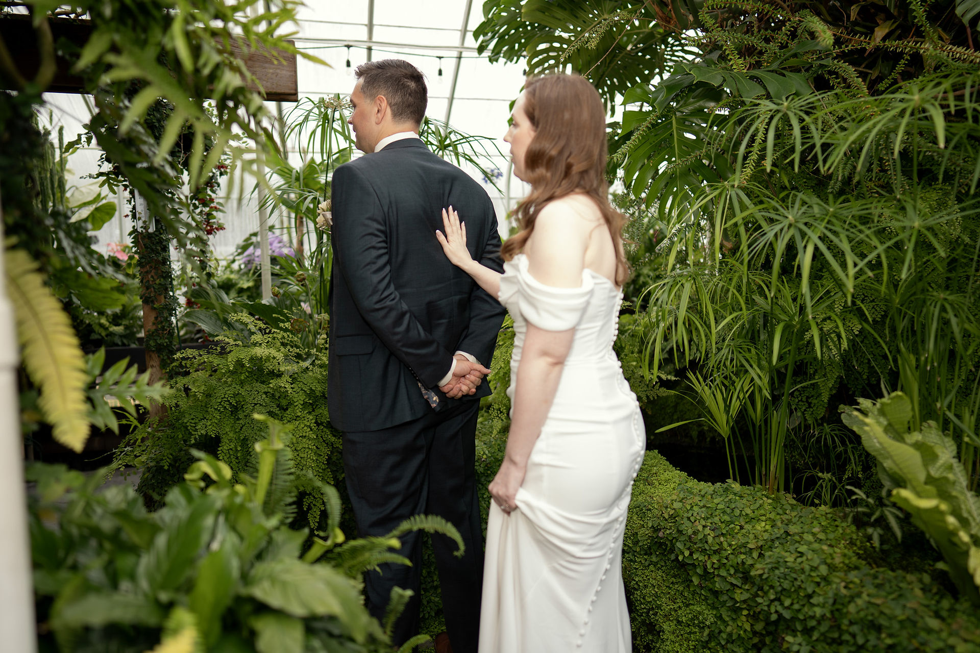 Bride touching groom's shoulder at Volunteer Park Conservatory Seattle.