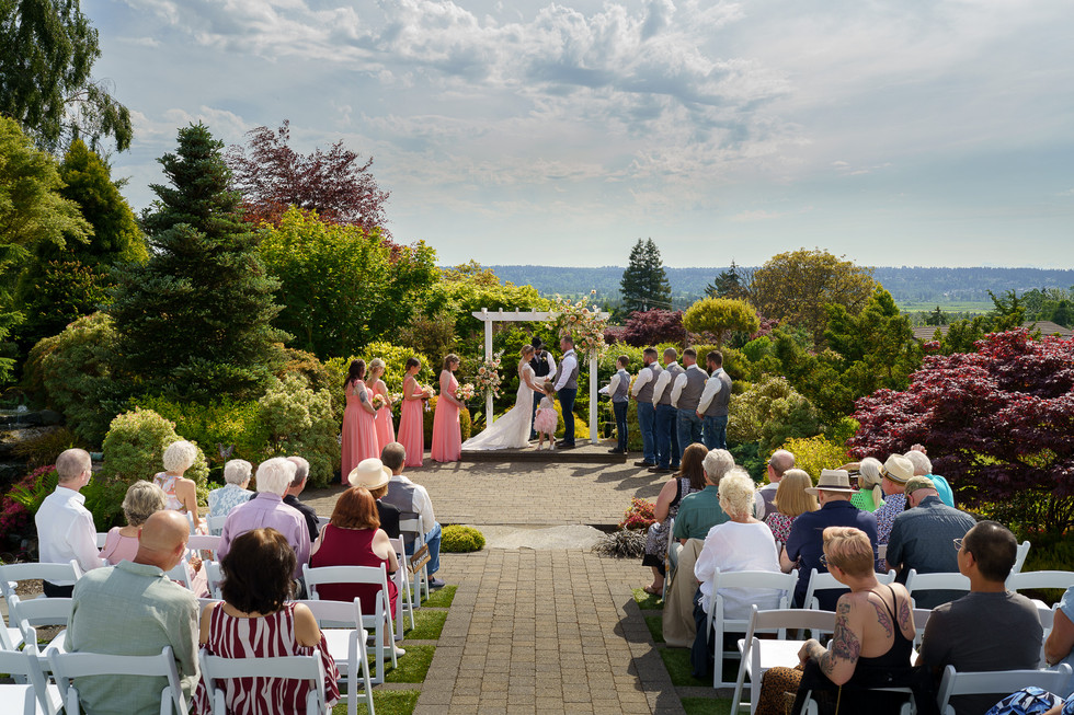 Outdoor wedding ceremony in lush garden, Weddings at Olympic View Wedding Estates.