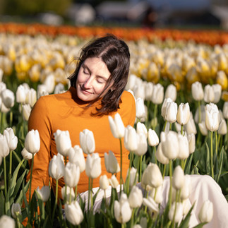 Smiling woman among white and yellow tulips at Skagit Festival
