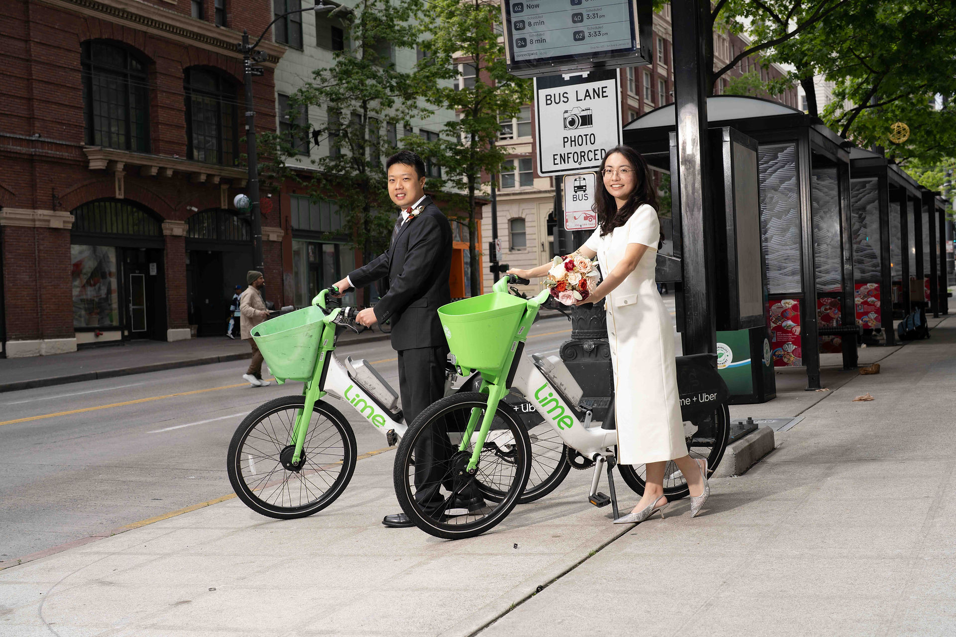 Couple on Lime bikes, wedding attire