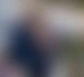 Emotional bride and groom at intimate farm wedding ceremony.