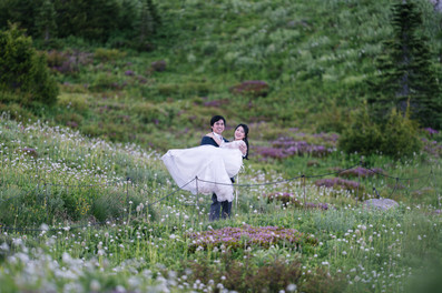 Groom carrying his bride during a Mount Rainier elopement.