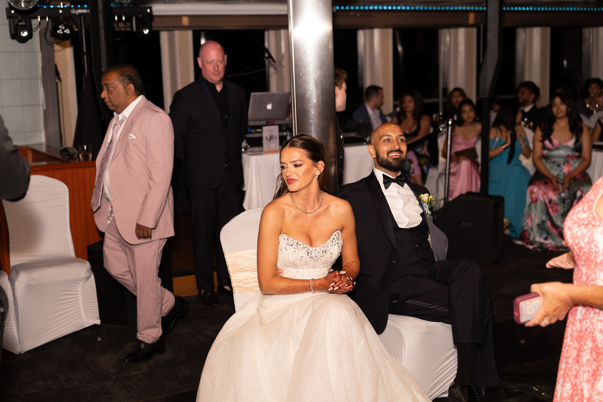Bride and groom seated at a reception by a WA wedding photographer.