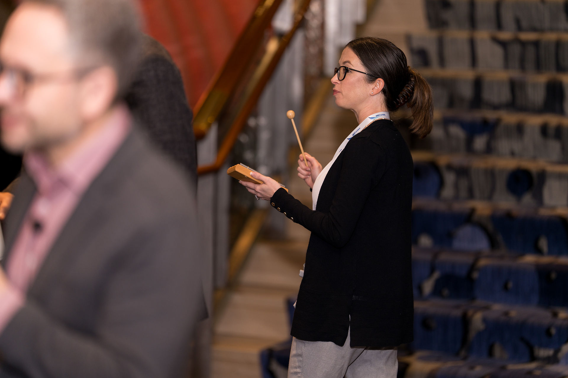 Woman with wooden block and mallet at Seattle event