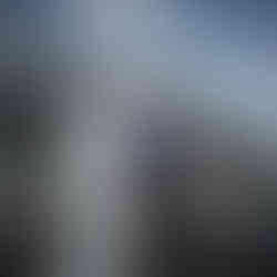 Bride and groom smiling at each other at an intimate farm wedding.
