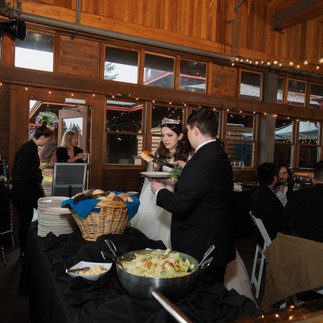 Bride and groom at a buffet during their Gold Mountain Golf Club wedding.