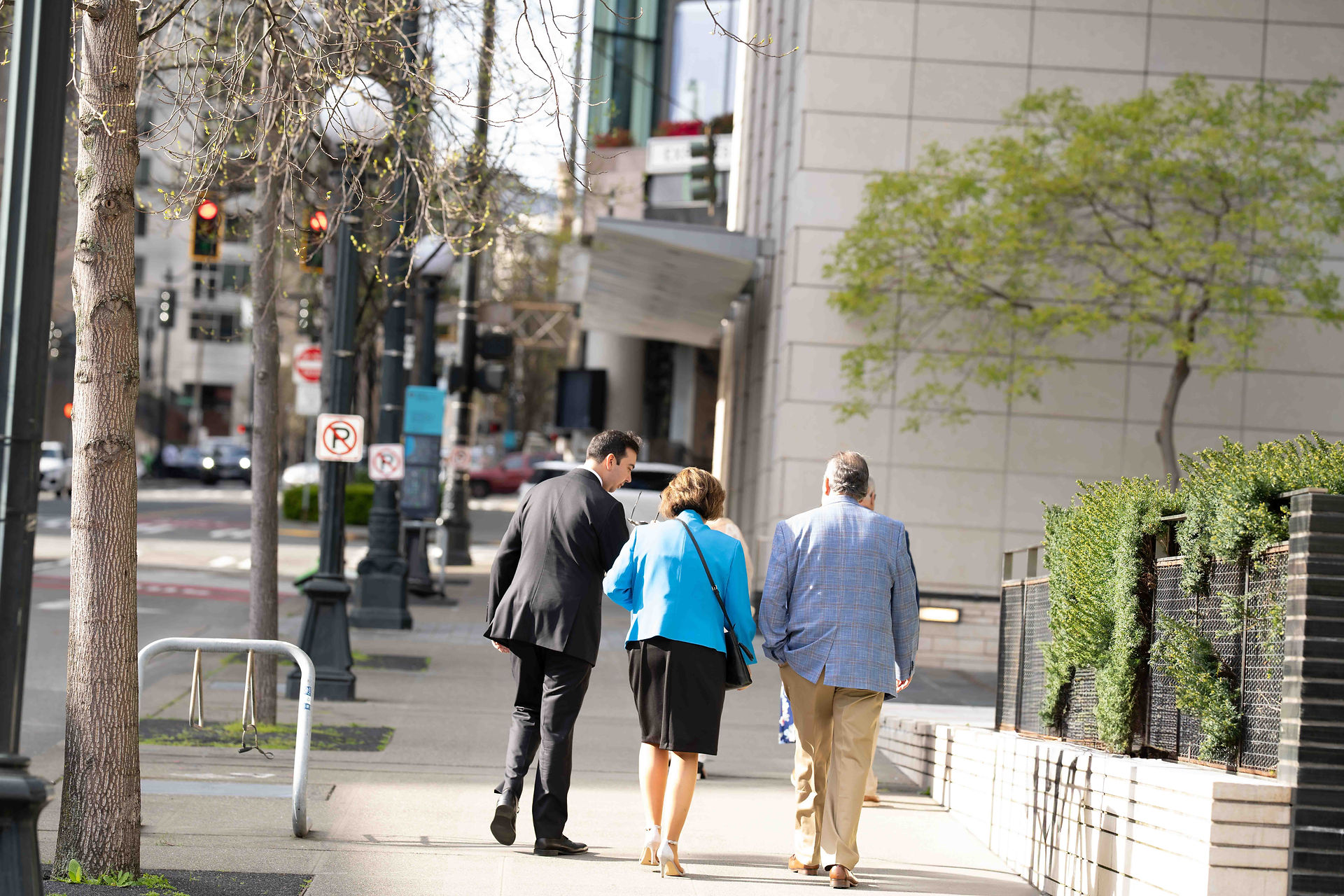 Four people walking downtown, city background