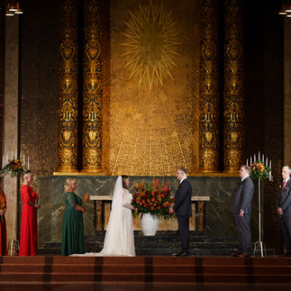 Bride and groom exchange vows in an ornate chapel wedding ceremony.