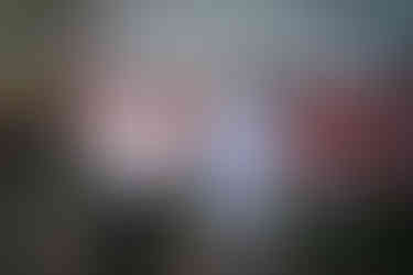 Woman and man talking outdoors at a rustic barn wedding.