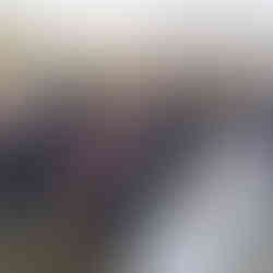 Guests, bride, and groom seated at an intimate farm wedding ceremony.