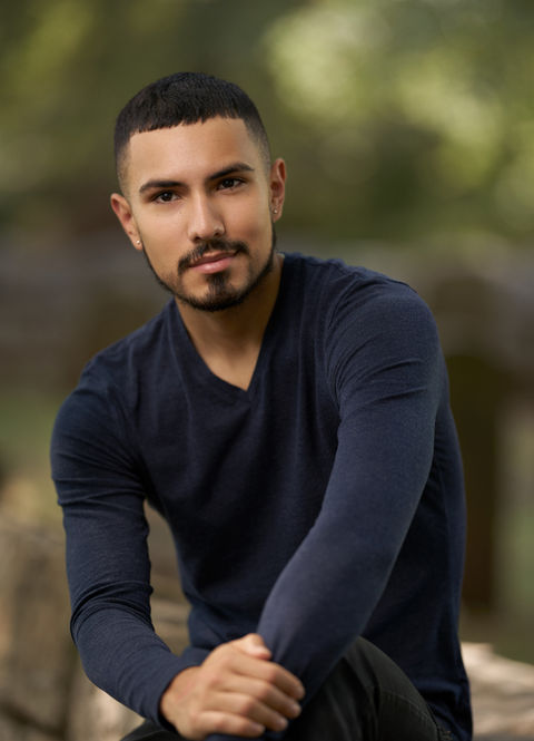 Headshot: Man in navy sweater