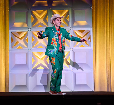 Singer in green suit performing on stage