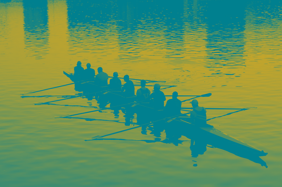 Eight people rowing a boat on calm water, silhouetted against rippling reflections. The mood is tranquil with harmonious teamwork.