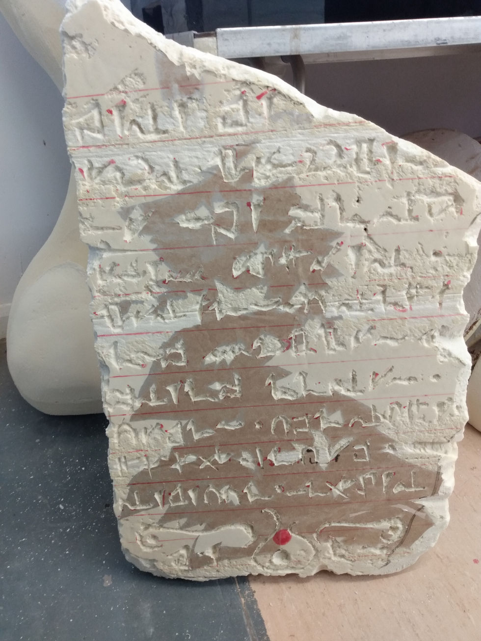 a plaque made of celotex with a fantasy language carved into it