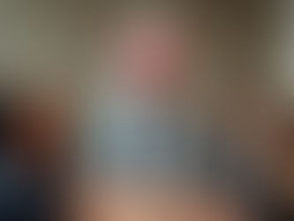 A man in a shark costume at a business meeting.