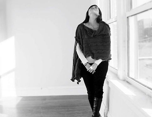ria in cable-knit poncho