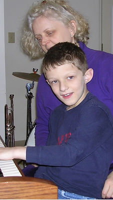 photo of a child and judith muir during a music lesson