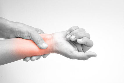 Person holding painful wrist highlighting wrist and hand pain | Jean Donati Acupuncture, Towson MD