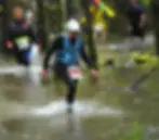 Marg wading through water during the Luxmore Grunt race TeAnau, Newzealand.