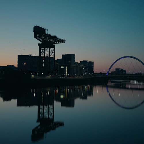Glasgow city skyline at dusk reflected in the River Clyde, filmed by Sole Productions